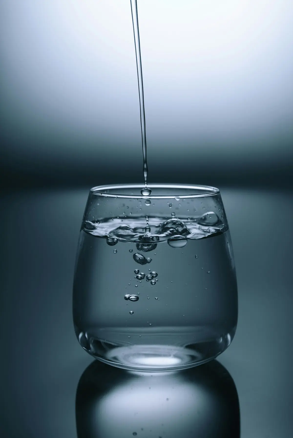 Glass of fresh water on a soft sunlit background